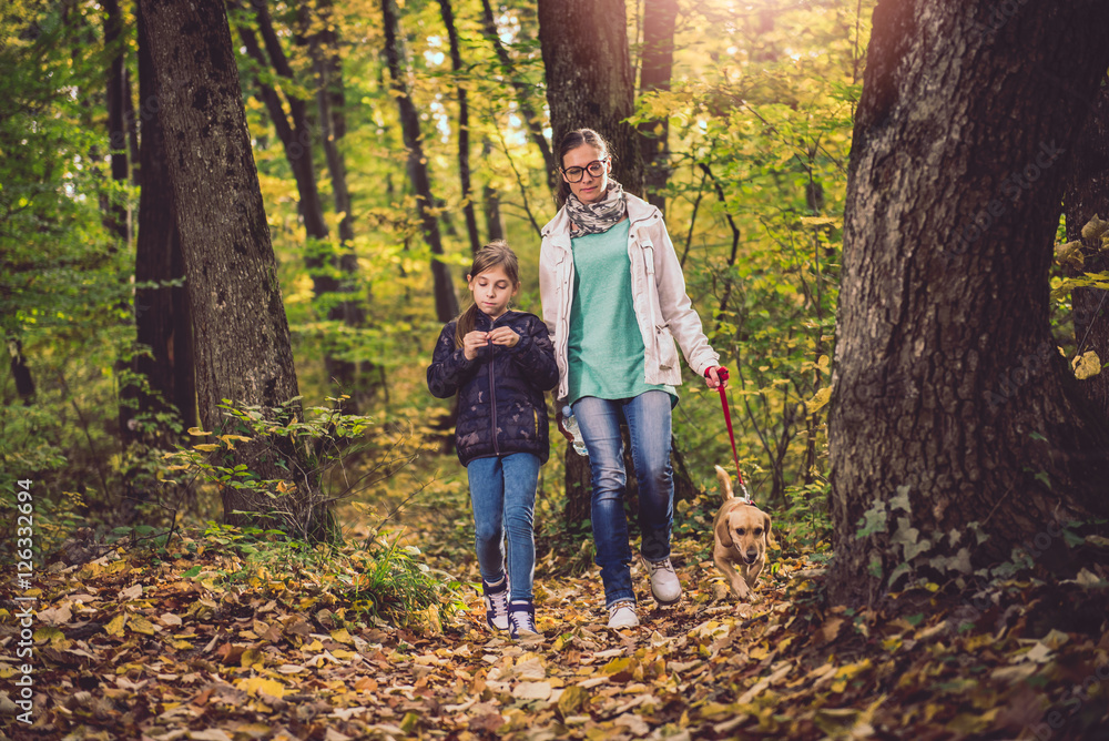 Mother and daughter hiking in a forest Mother and daughter hiking in a forest
