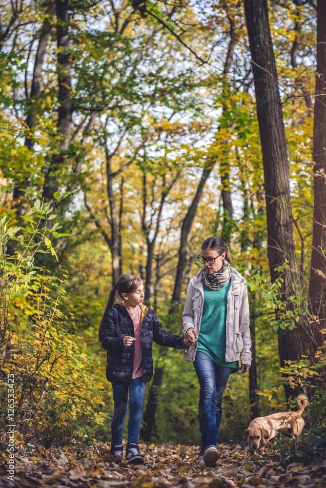 Mother and daughter hiking in a forest