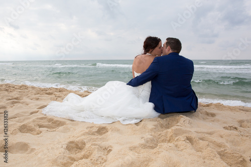 Couple in love sitting in blue beach on vacation travel © OceanProd
