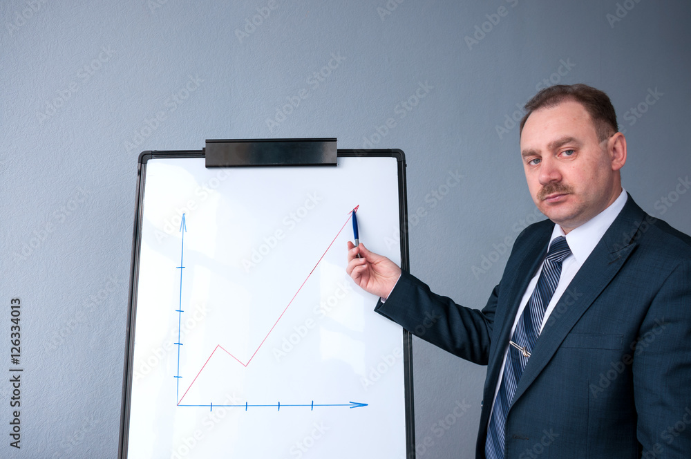 A man in a suit shows a growing profit A man in a suit shows a growing profit