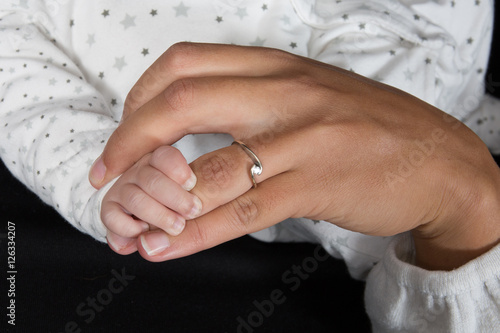 Family Baby Hands. Mother Holding Newborn Kid.