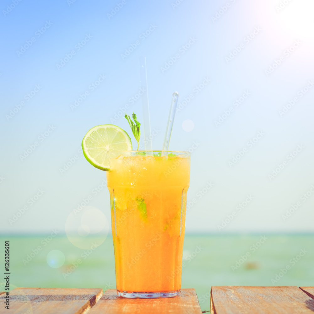 Mango mojito on the wooden pier. Concept of luxury tropical vaca Mango mojito on the wooden pier. Concept of luxury tropical vaca