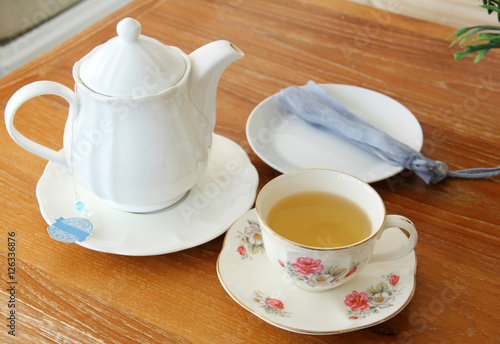Vintage cup of tea with teapot