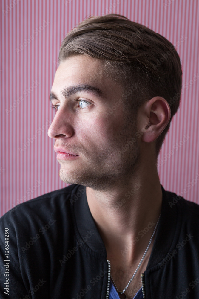 Fototapeta premium Portrait of an handsome young man with interesting background a