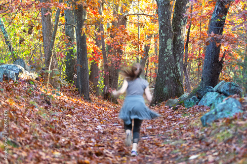 Girl Jogging in the Woods in Fall © flysnow