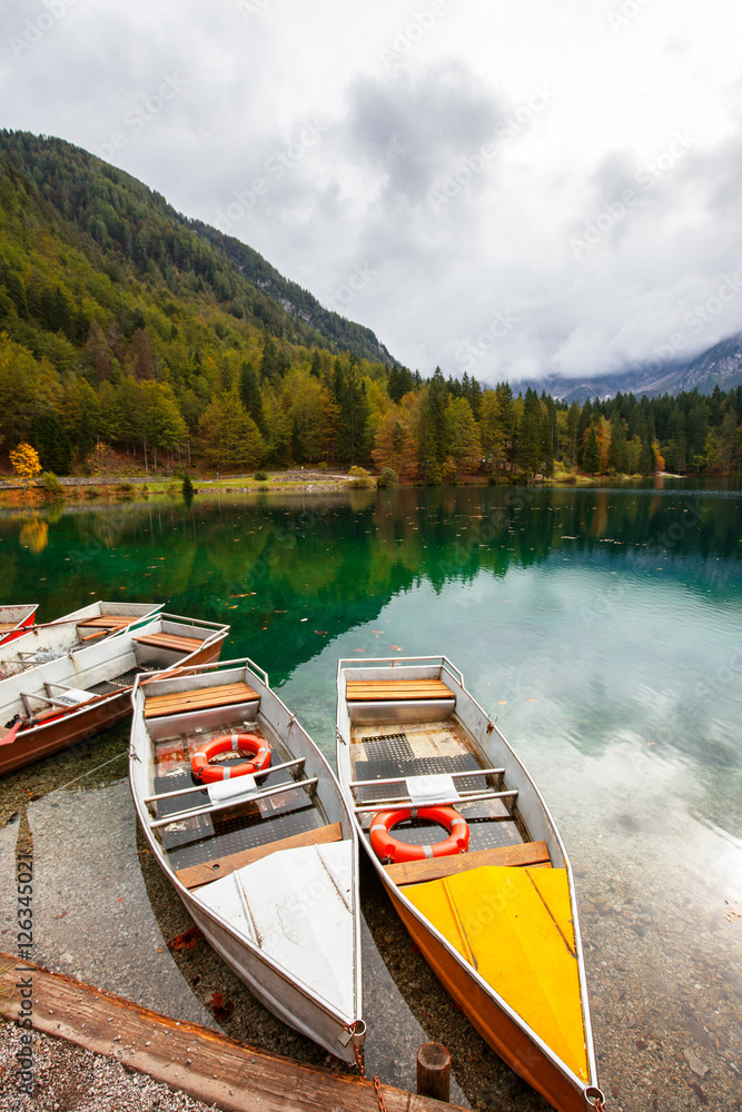 Alpine landscape and colorful boats, Lake Fusine,Italy