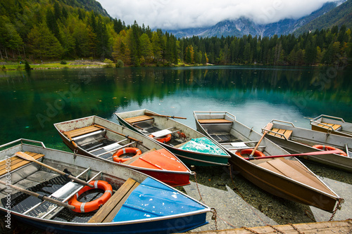 Alpine landscape and colorful boats, Lake Fusine,Italy photo