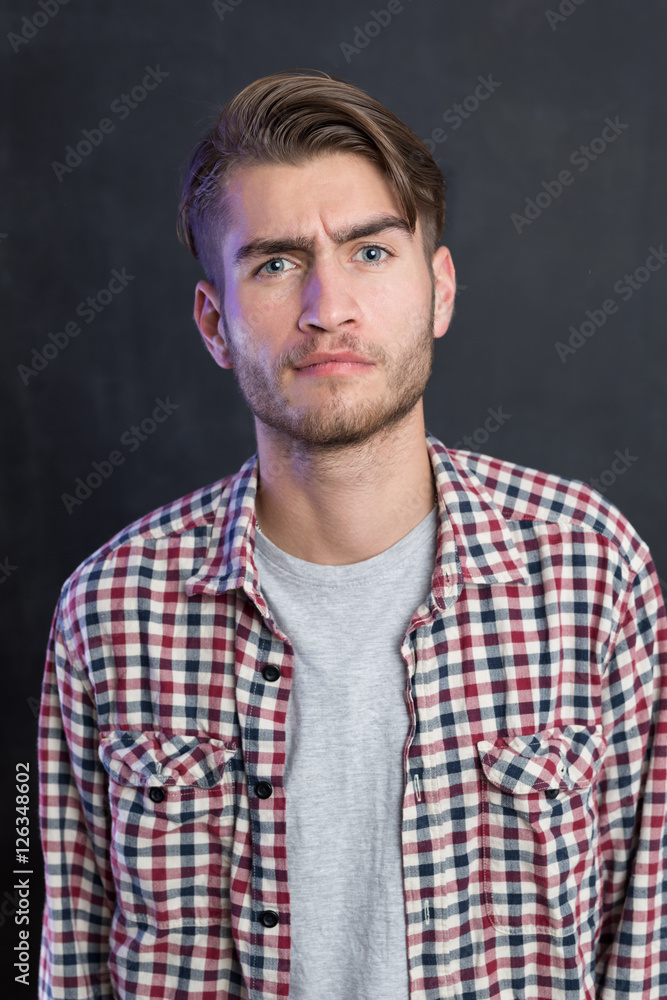 Portrait of a cheerful young man in checkered shirt