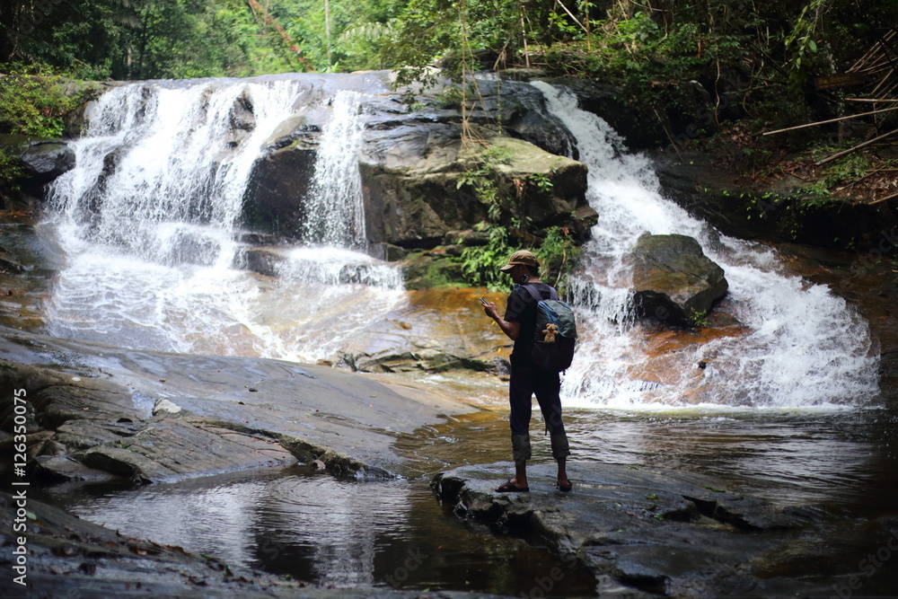 Man and Khao Cha Mao Waterfall in Rayong Thailand Man and Khao Cha Mao Waterfall in Rayong Thailand