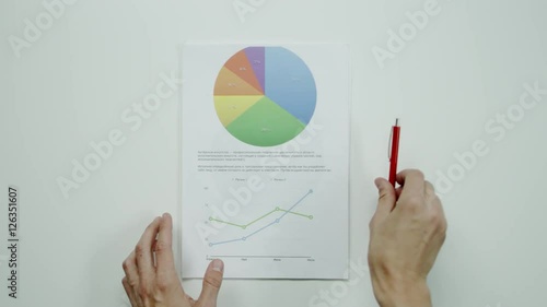 Male hands hold graphic charts. photo