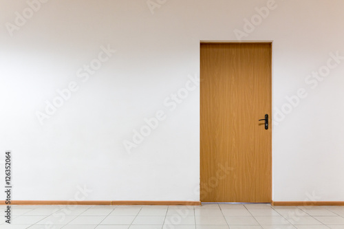 Wooden door on a clean wall indoors