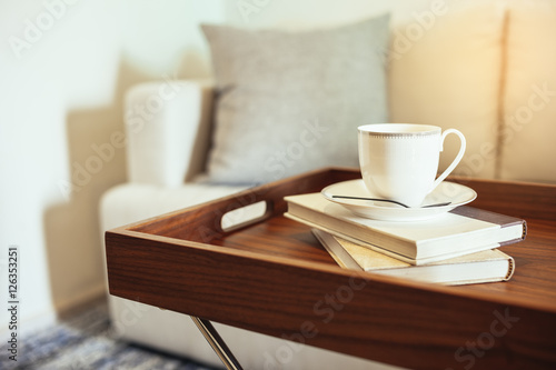 Pillow on sofa Home Interior Coffee cup Books on table wooden tray table