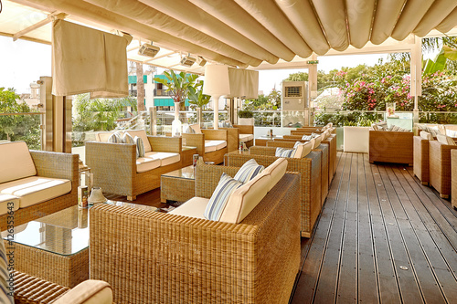 Soft sofas and tables in the beach cafe terrace.