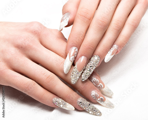 Beautifil wedding manicure for the bride in gentle tones with rhinestone. Nail Design. Close-up.