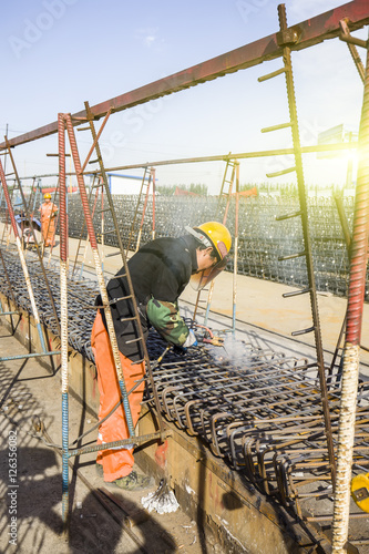 In the construction site, the welding workers at work