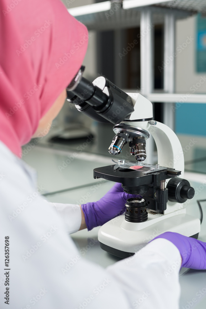 muslim lab worker doing an analysis muslim lab worker doing an analysis