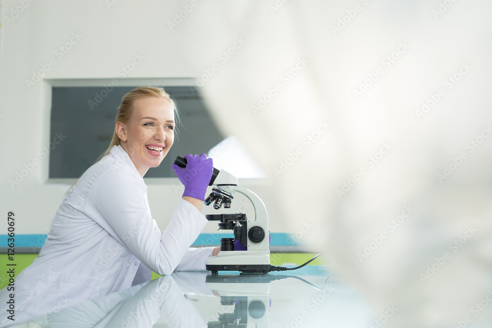 Young scientist in white uniform working in laboratory Young scientist in white uniform working in laboratory