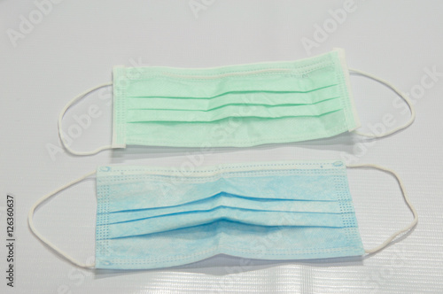 Green medical surgical flu illness protective mask over isolated