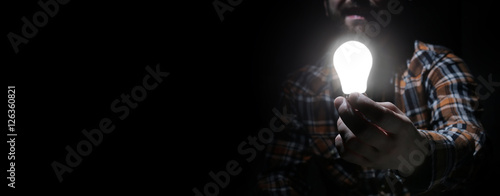 man in dark with glow bulb