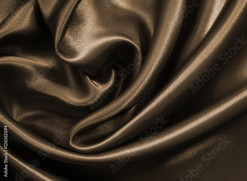 Smooth elegant golden silk or satin as background. In Sepia tone