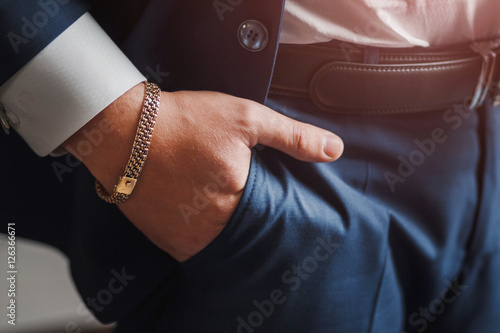 body detail of a business man. Closeup hand with jewelry chain in pocket