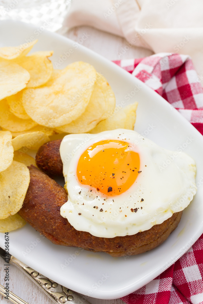 fried portuguese sausage alheira with egg and potato chips fried portuguese sausage alheira with egg and potato chips