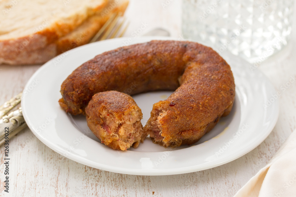 fried portuguese sausage alheira on white plate and bread fried portuguese sausage alheira on white plate and bread