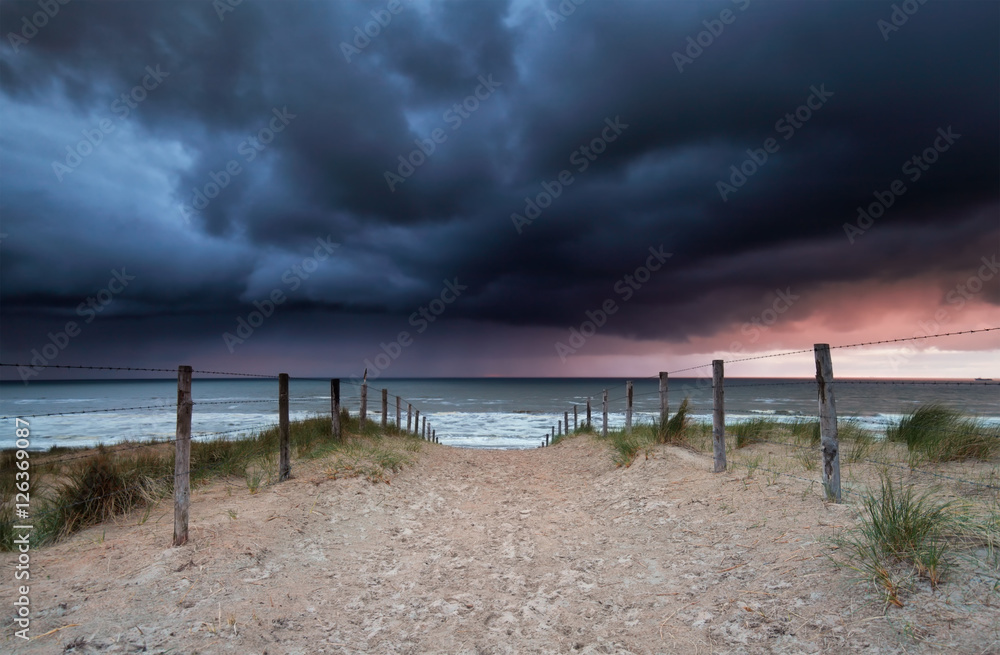 stormy sunset over beach in North sea