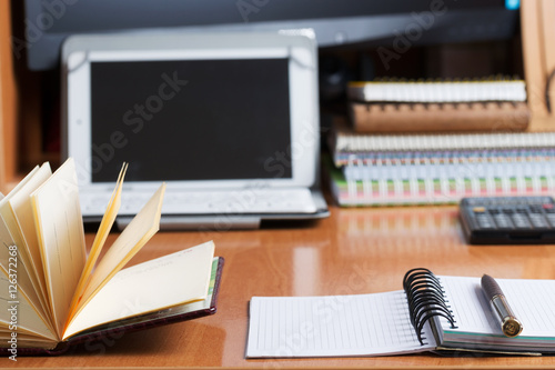 Office desk table with computer, calculator, supplies. Copy space for text