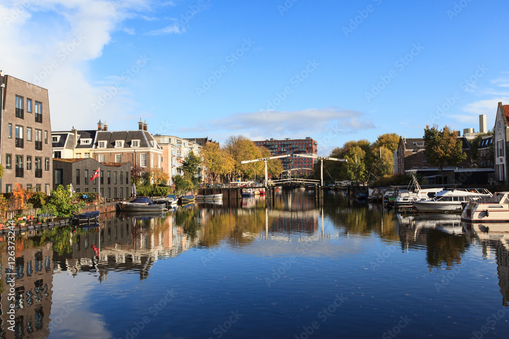 Beautiful view of canals in autumn sunny day,  Amsterdam, Netherlands 
