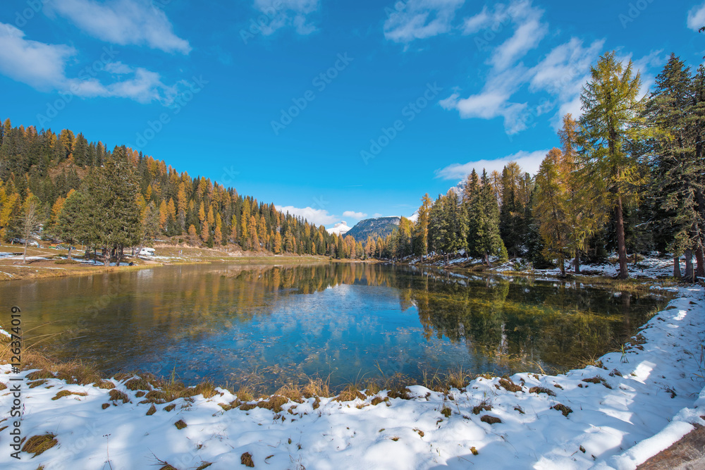The charming landscape with snowy pond on the Antorno Lake, Dolo