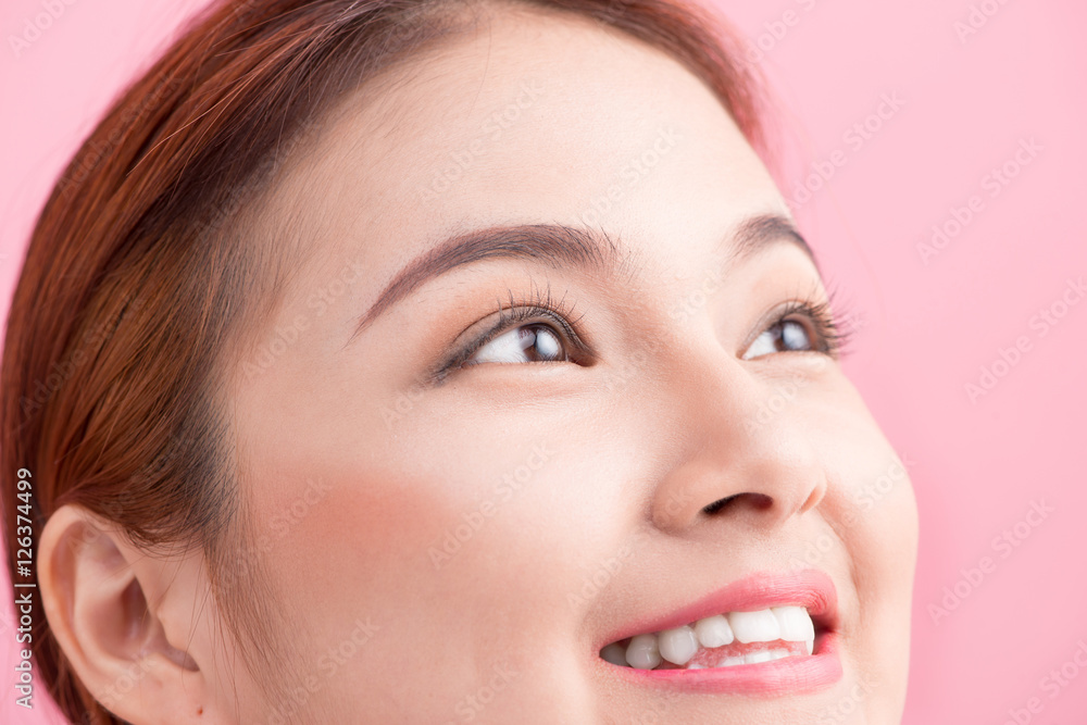 Beautiful asian woman eye with long eyelashes isolated on pink b Beautiful asian woman eye with long eyelashes isolated on pink b