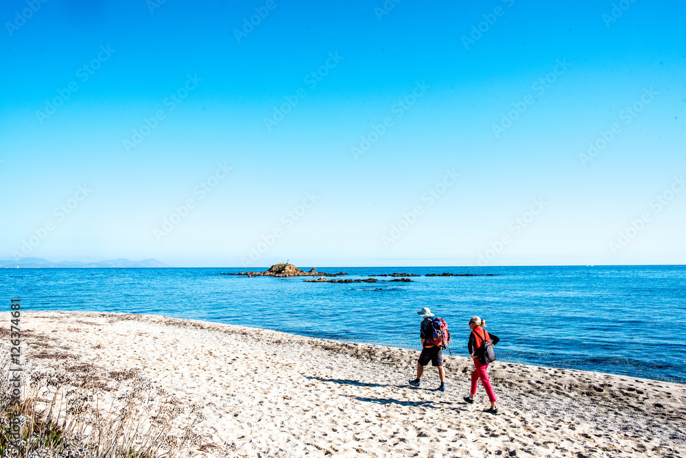 2 hikers on a beach near the Mediterranean Sea