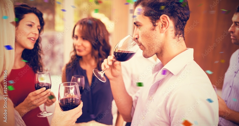 Composite image of group of friends having wine Composite image of group of friends having wine
