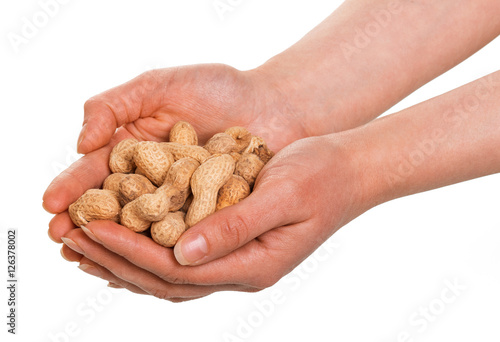 In human hands peanuts in the shell isolated on white .