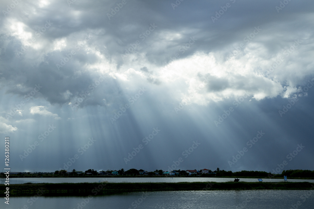 Great light through cloud to ground and water