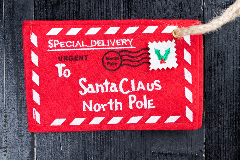 Red letter to Santa Claus envelope with jute twine attached.
