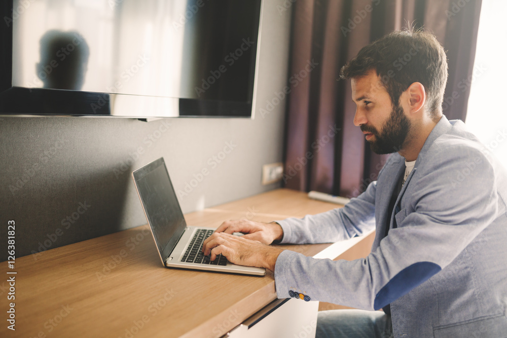 Handsome man working on laptop Handsome man working on laptop