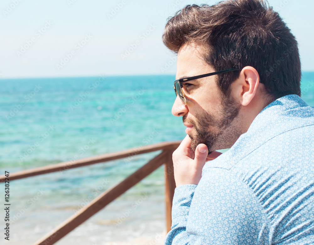 Fototapeta premium young man thinking in the beach