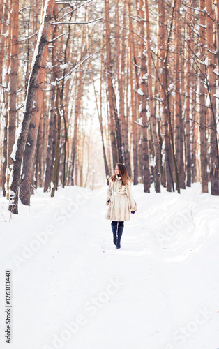 Girl walking in snow. Winter, cold and people concept