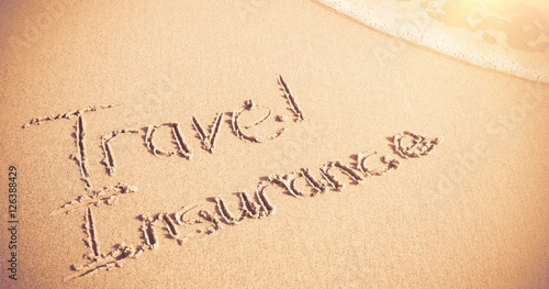 Travel Insurance written on sand