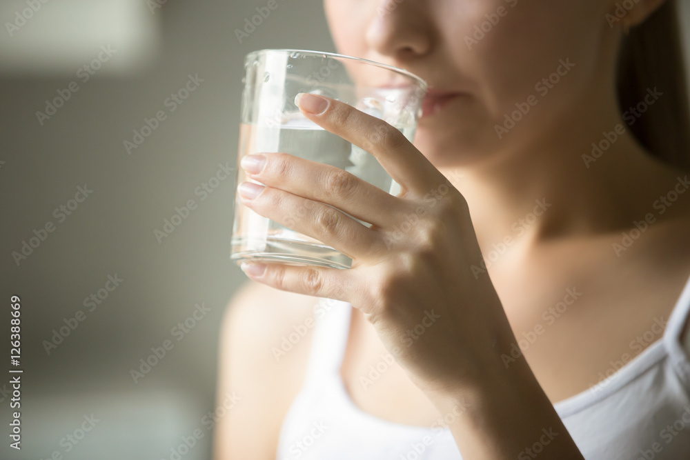 Female drinking from a glass of water. Health care concept photo, lifestyle, close up Female drinking from a glass of water. Health care concept photo, lifestyle, close up