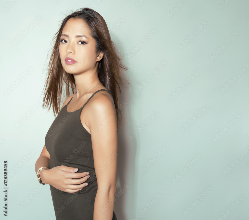 beautiful young asian woman with long hair posing in casual clothes and wearing a wrist watch beautiful young asian woman with long hair posing in casual clothes and wearing a wrist watch