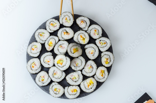 Maki sushi, rolls on slate plate.