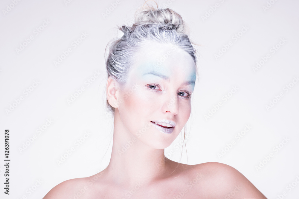 Model in creative image with silver blue artistic make-up