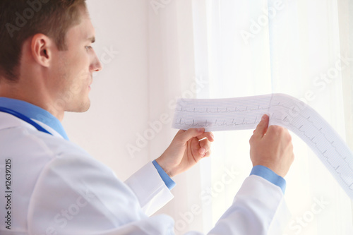 Young male doctor looking a...