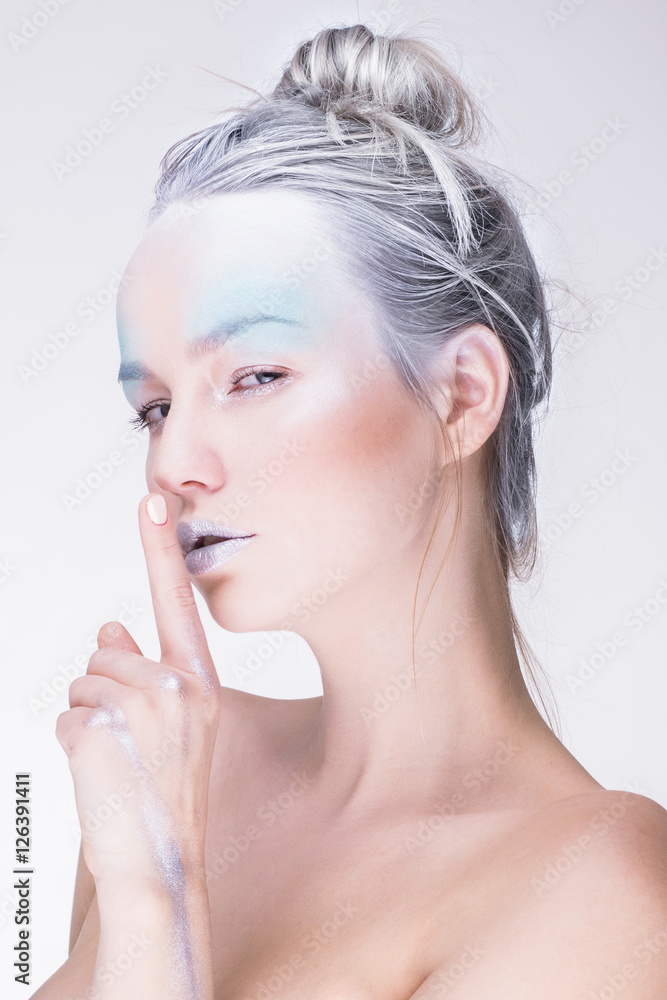 Naklejka premium Model in creative image with silver blue artistic make-up