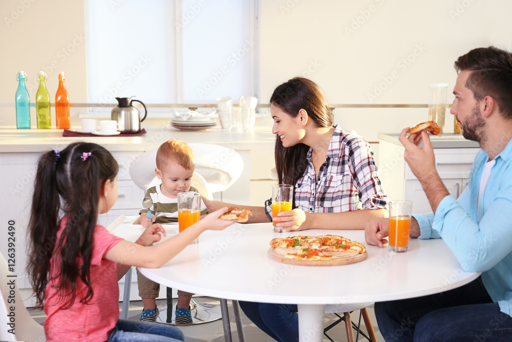 Happy family eating food on kitchen Stock Photo | Adobe Stock