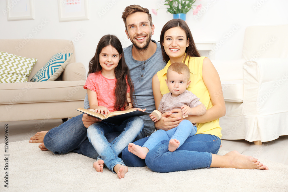 Happy family reading book at home Happy family reading book at home