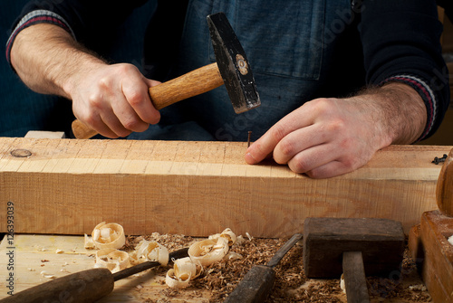 Carpenter tools on wood table background. Top view. Copy space